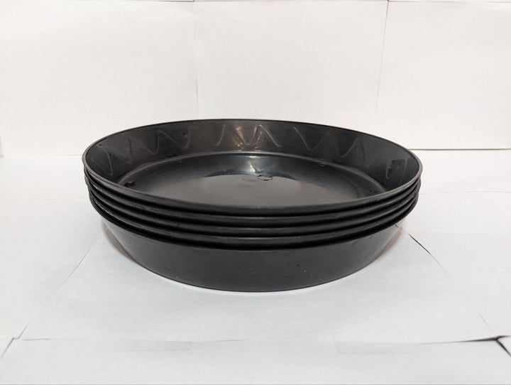 Stack of Green Oasis heavy-duty black plant saucers