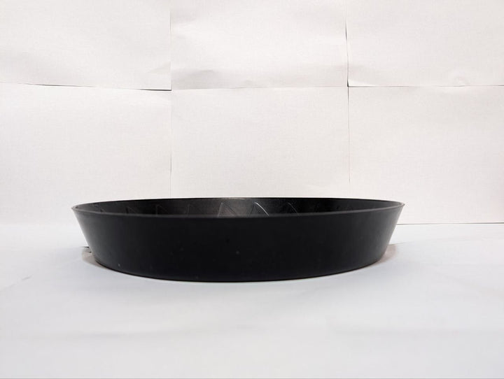 Black plant saucer catching water runoff – Green Oasis